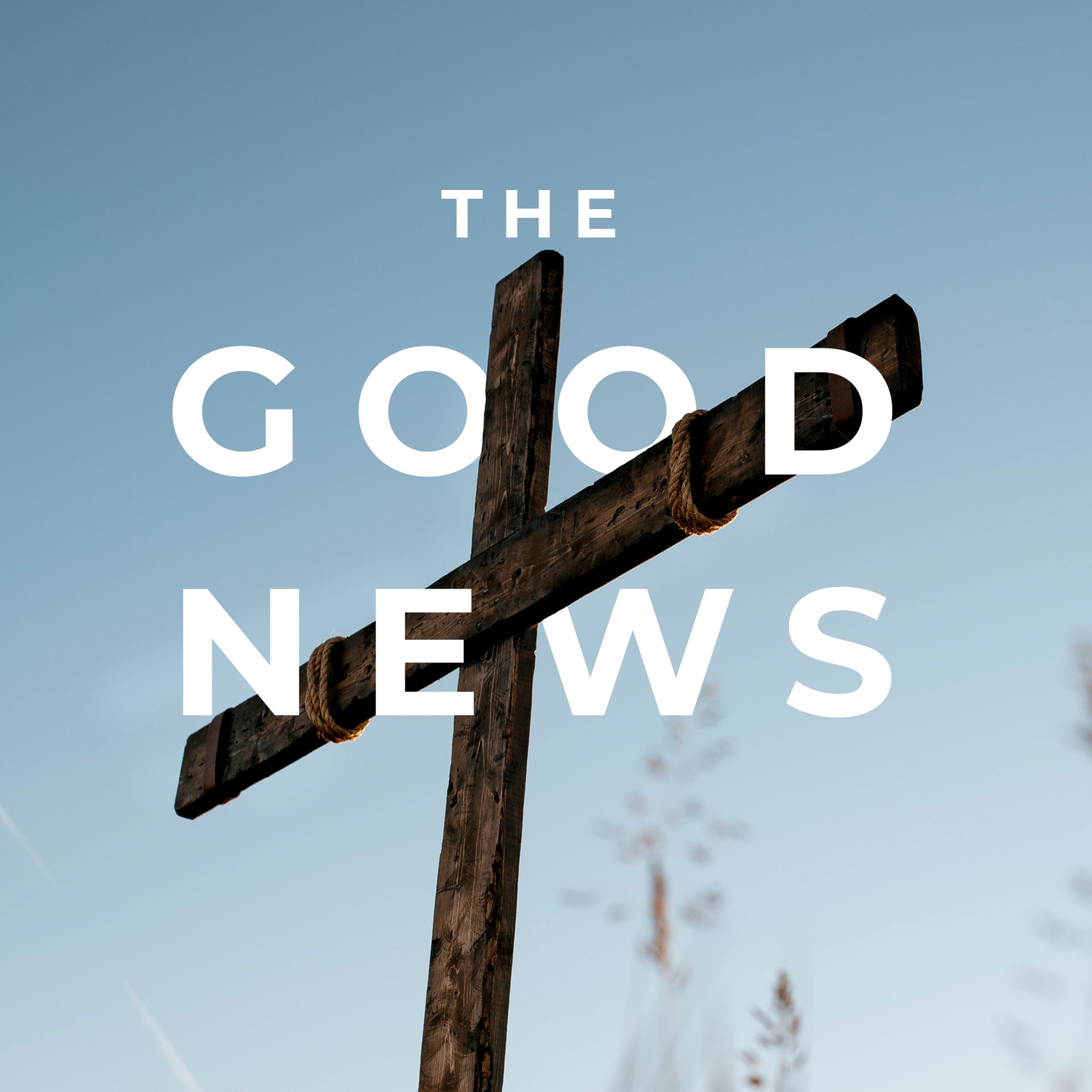 Wooden cross against a blue sky with the words “THE GOOD NEWS” overlaid