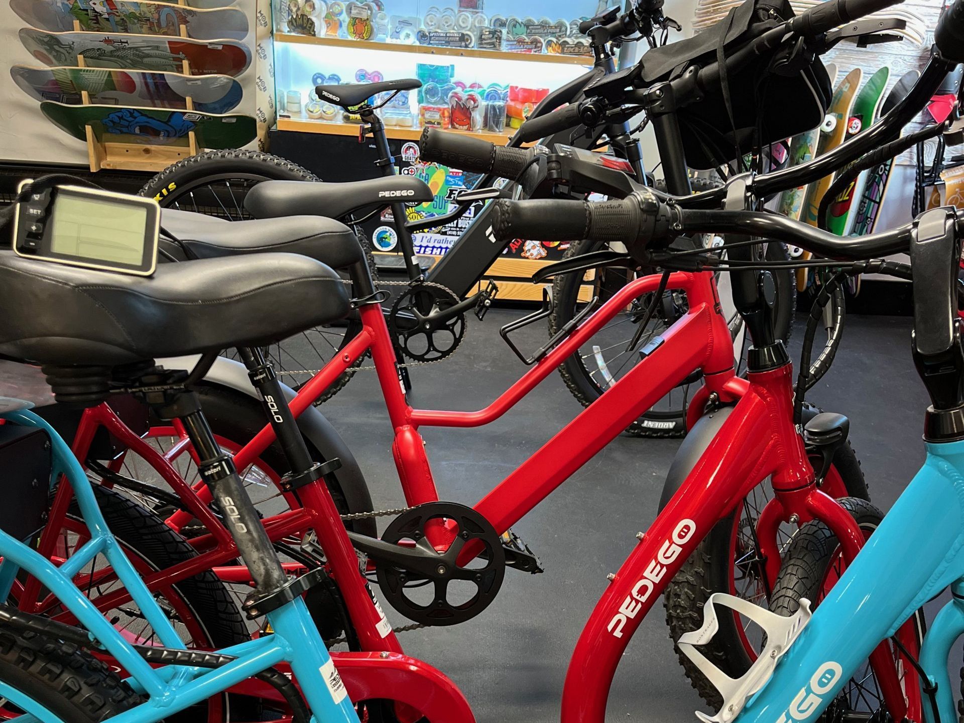 A row of bicycles are lined up in a store.