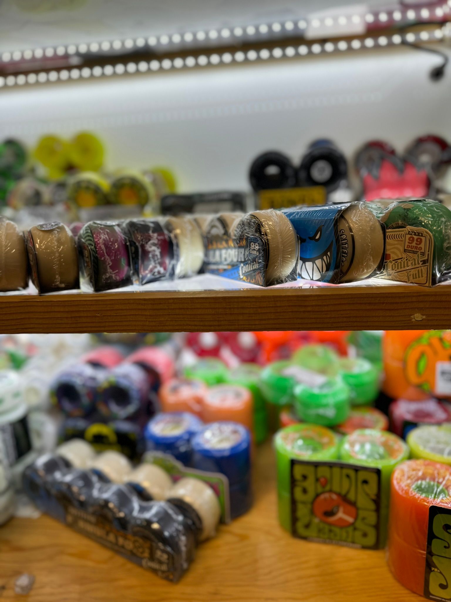 Colorful dice and small trinkets arranged on a shelf in a softly lit display case