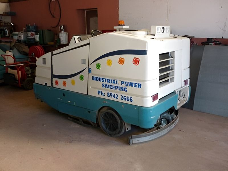 White And Blue Power Sweeper Parked In Garage — Industrial Power Sweeping Services Pty Ltd In Knuckey Lagoon, NT