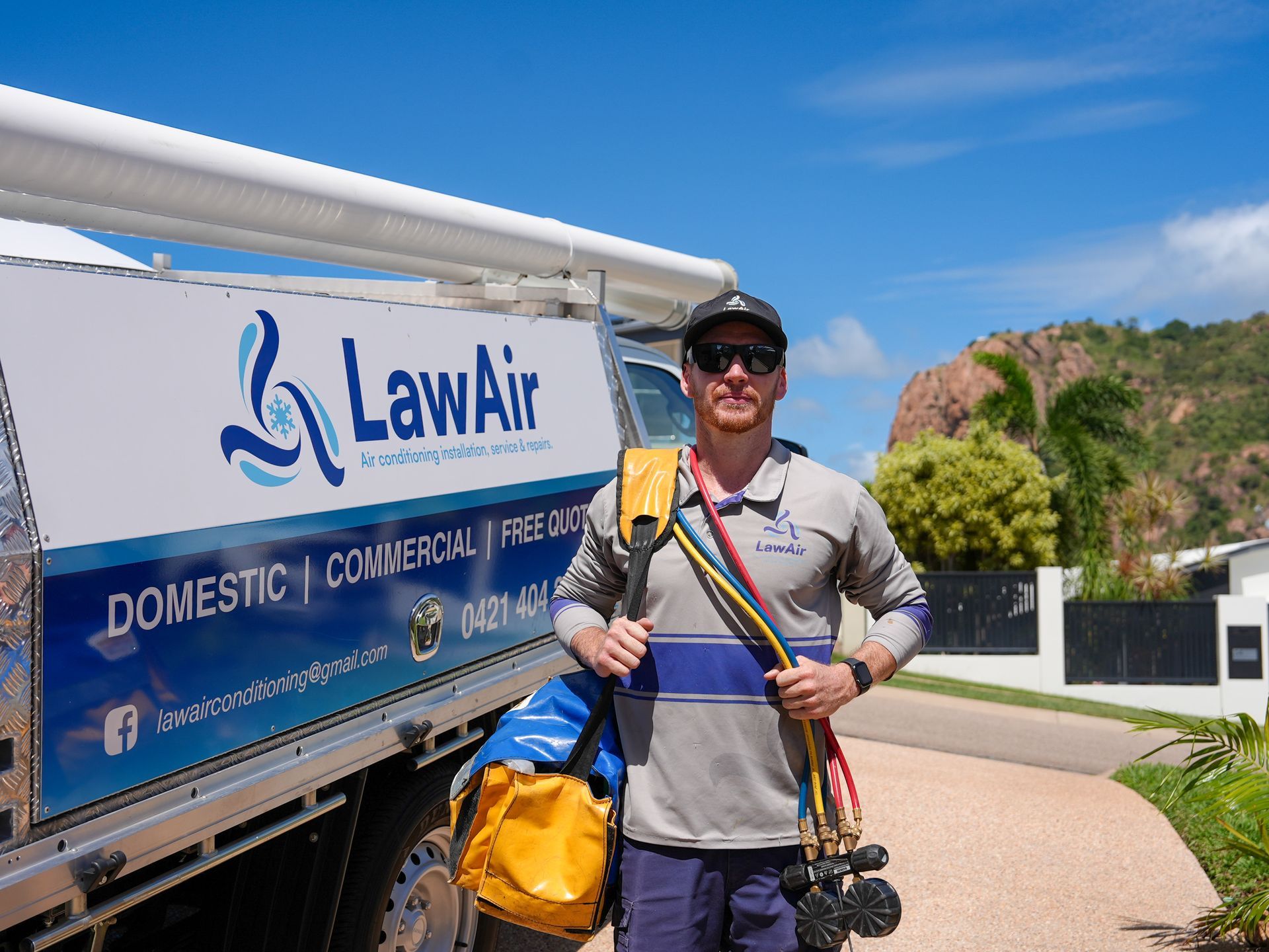 A Man Installing A New Air Conditioner  — Law Air Conditioning In Annandale, QLD
