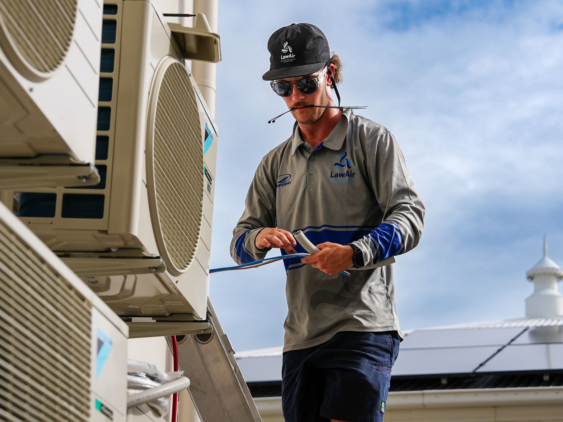 Wiring Of An Air Conditioner On A Brick Wall — Law Air Conditioning In Annandale, QLD