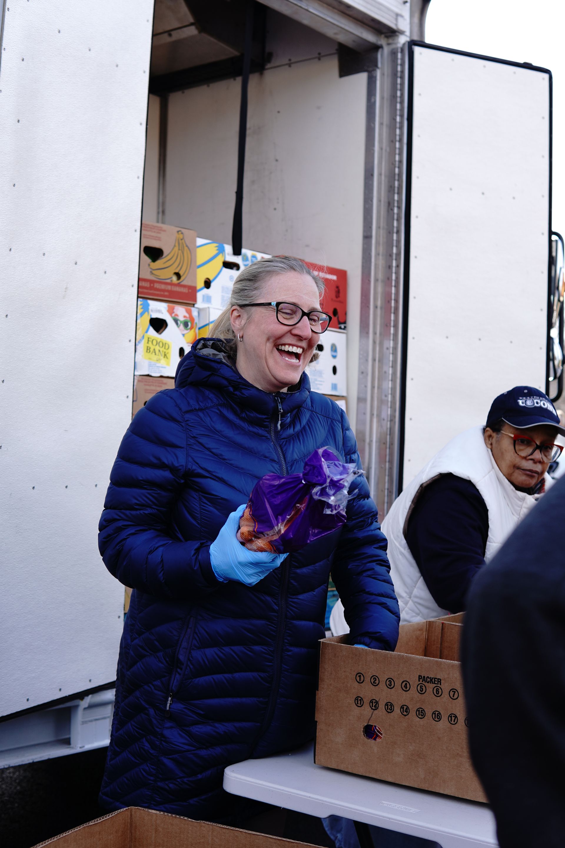 Molly Devanney, Connecticut Foodshare board member, at the mobile food pantry in Manchester's Squire Village, where she has been volunteering since 2020.