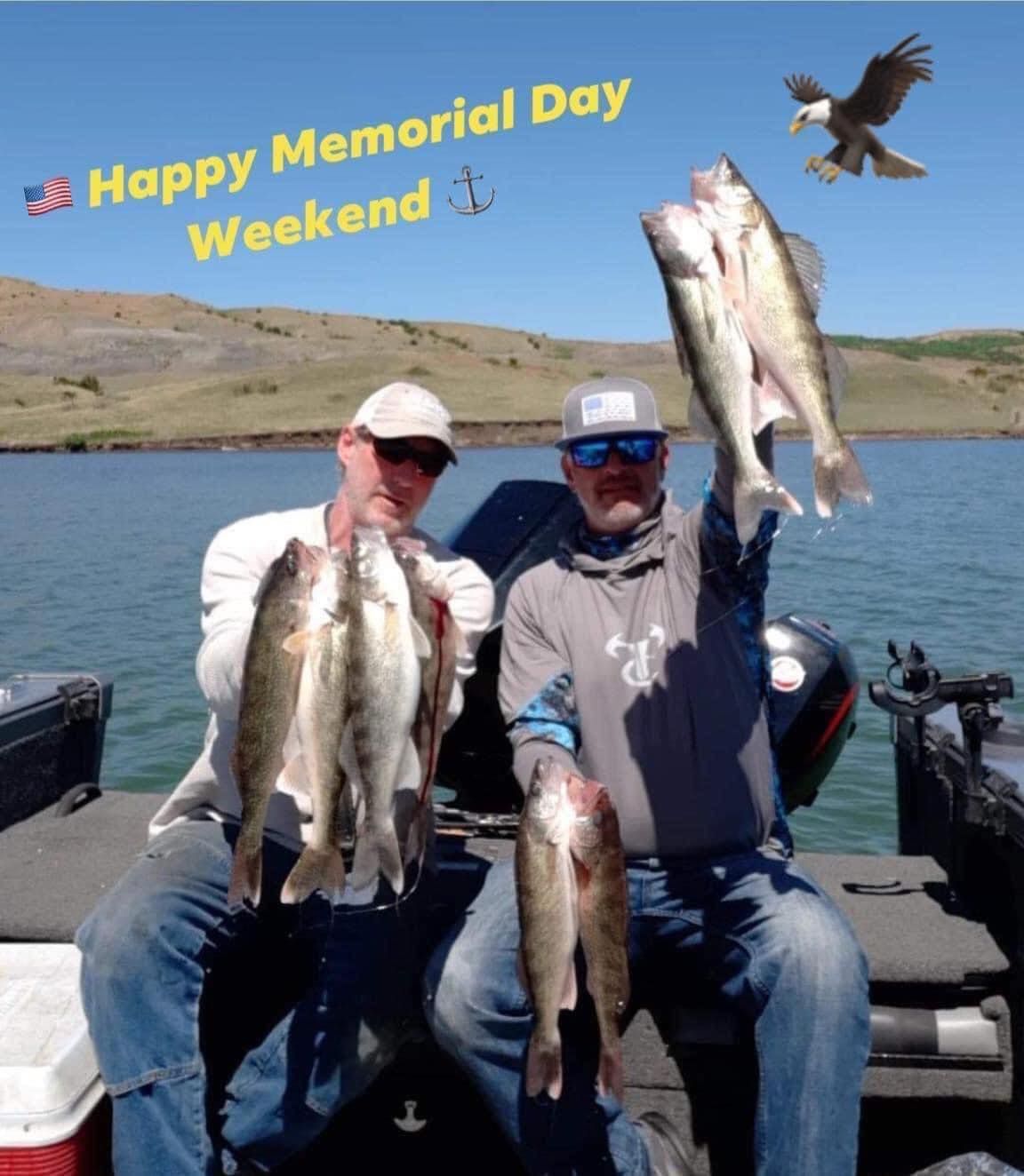 Two men on a boat, holding up caught fish. Happy Memorial Day Weekend. An eagle flies overhead.
