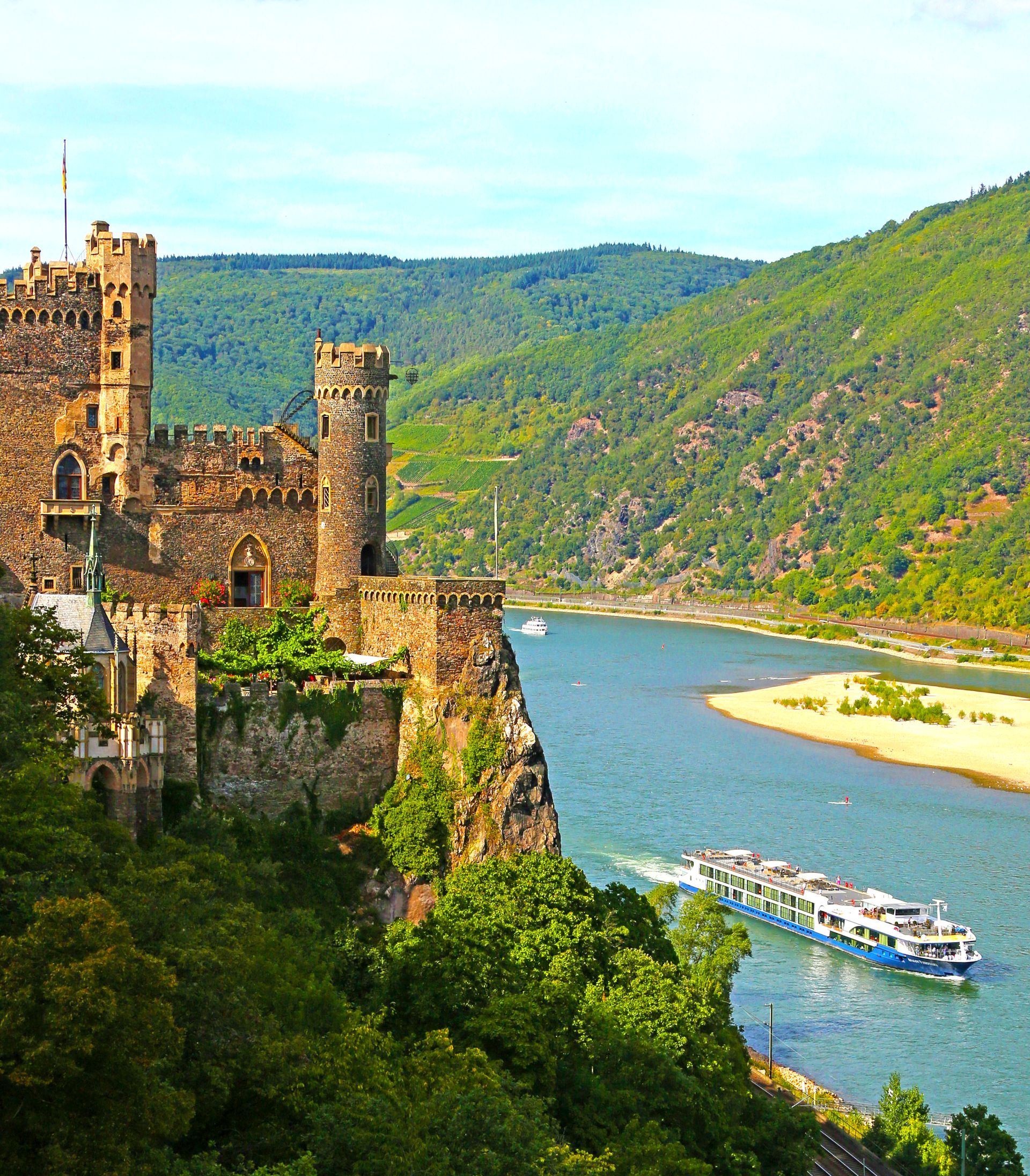 An Avalon cruise ship passes a castle on a hill