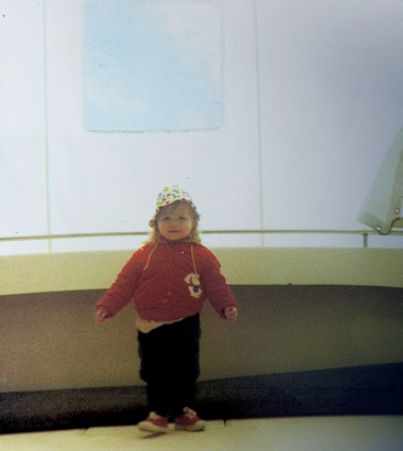 A female toddler in a bucket hat on a boat