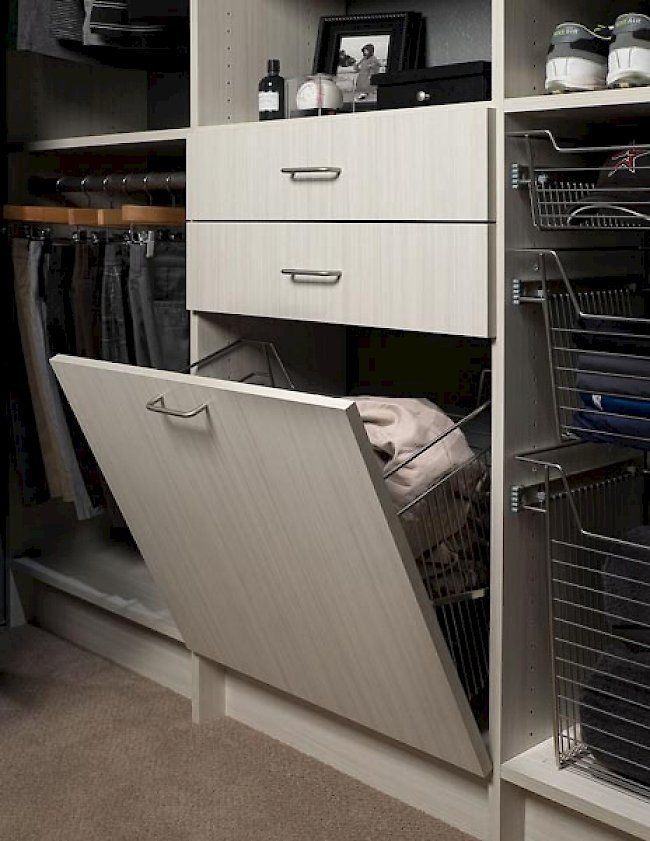 A closet with drawers and a laundry basket