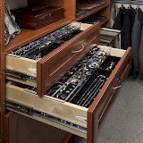 A closet filled with lots of jewelry in a drawer.