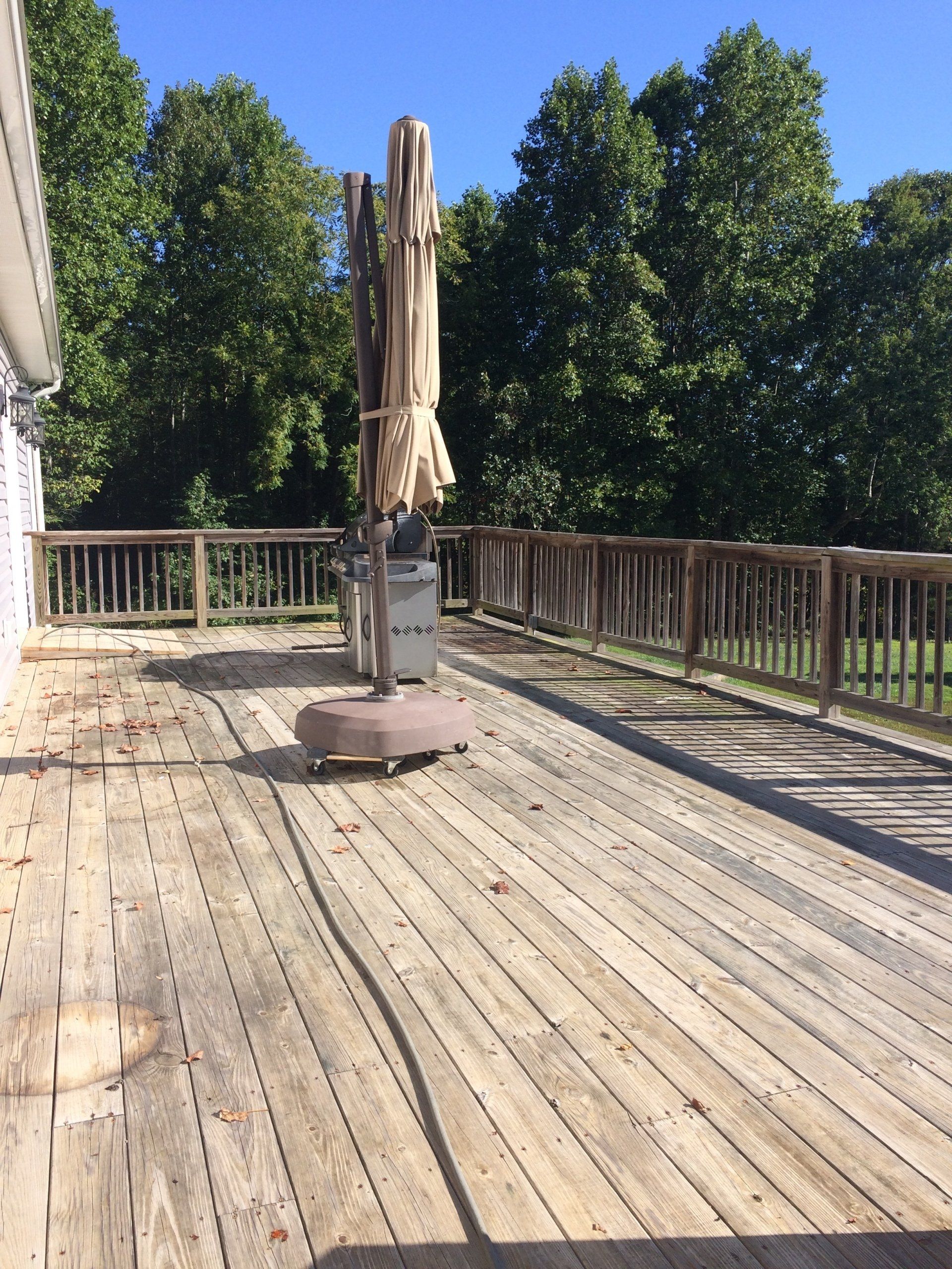 dirty old terrace with umbrella and grill
