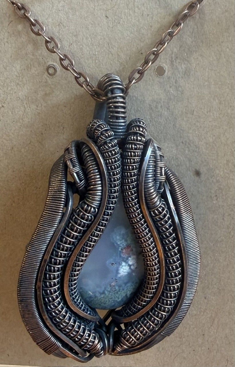 Copper wire pendant with a teardrop blue stone on a chain