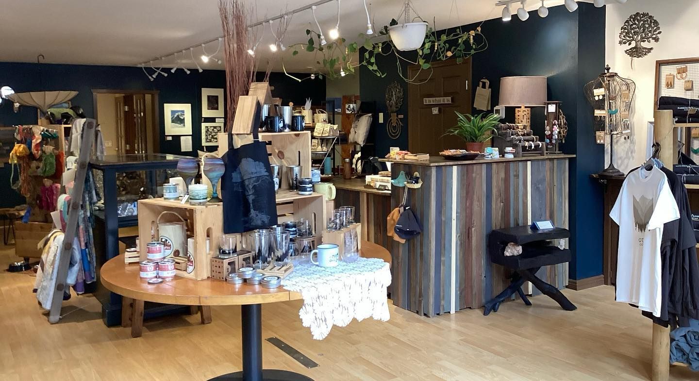 Boutique clothing shop interior with wooden displays, hanging lights, and casual apparel racks