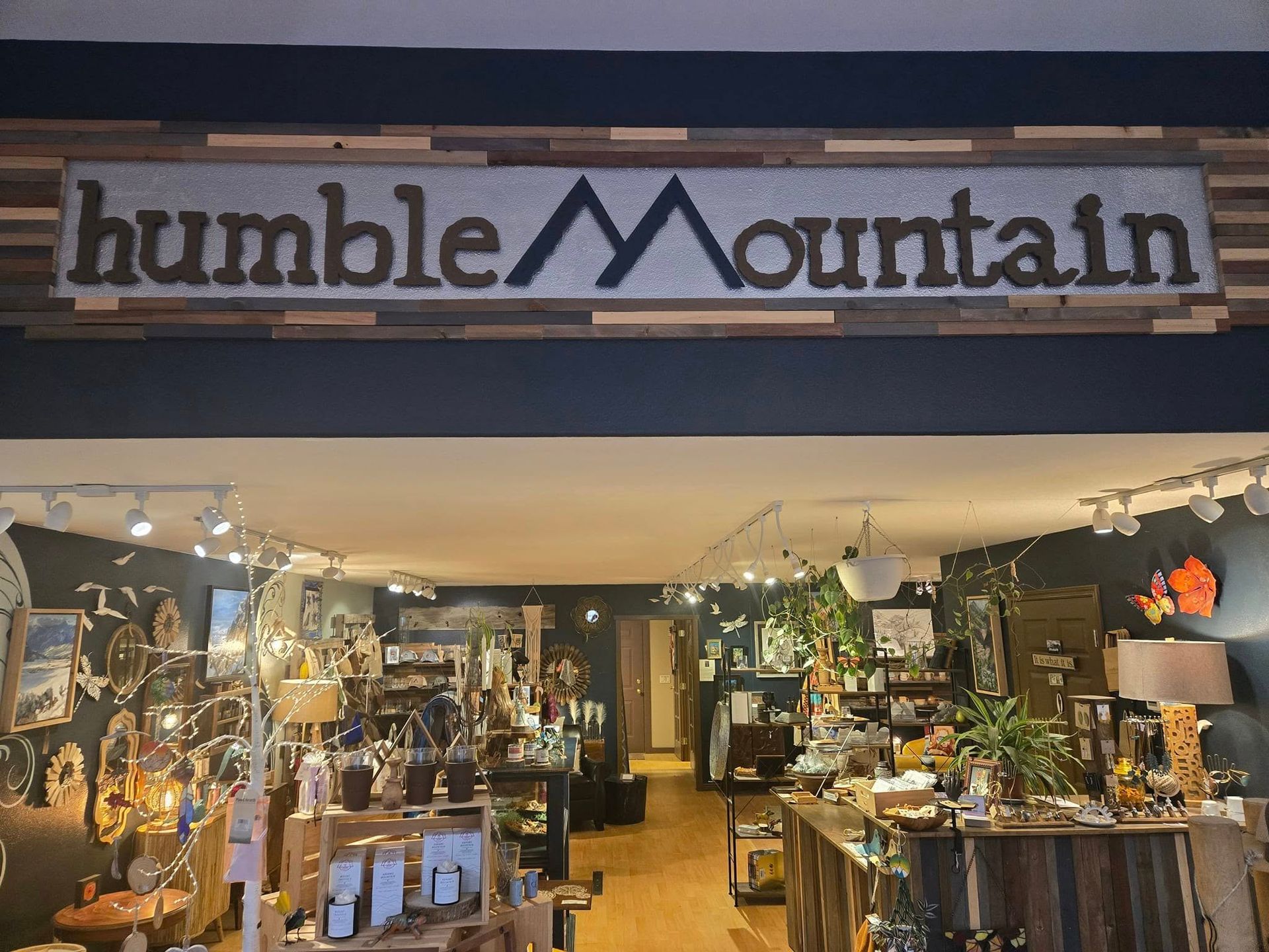 Humble Mountain shop sign above a cozy, dimly lit artisan retail display