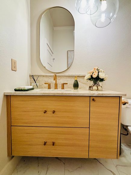 Custom bathroom vanity cabinet with rich wood tones and stone countertop installed in a Texas home
