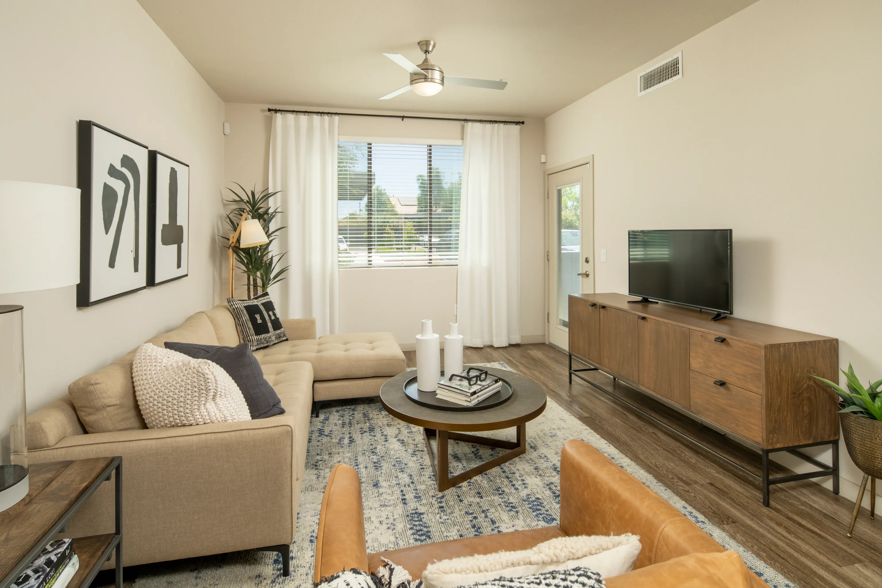 Furnished apartment living area shown — representative home at Parc South Mountain.
