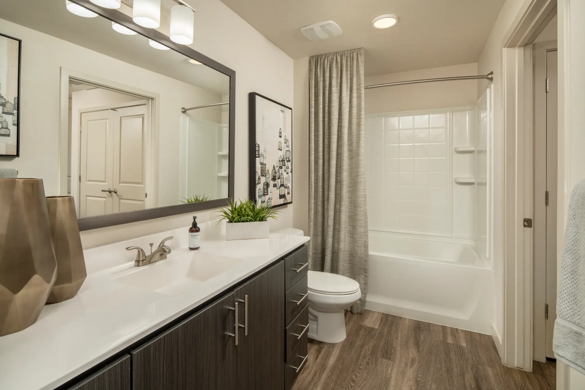 Bathroom with vanity, toilet, and bathtub at Parc South Mountain in Phoenix, AZ.