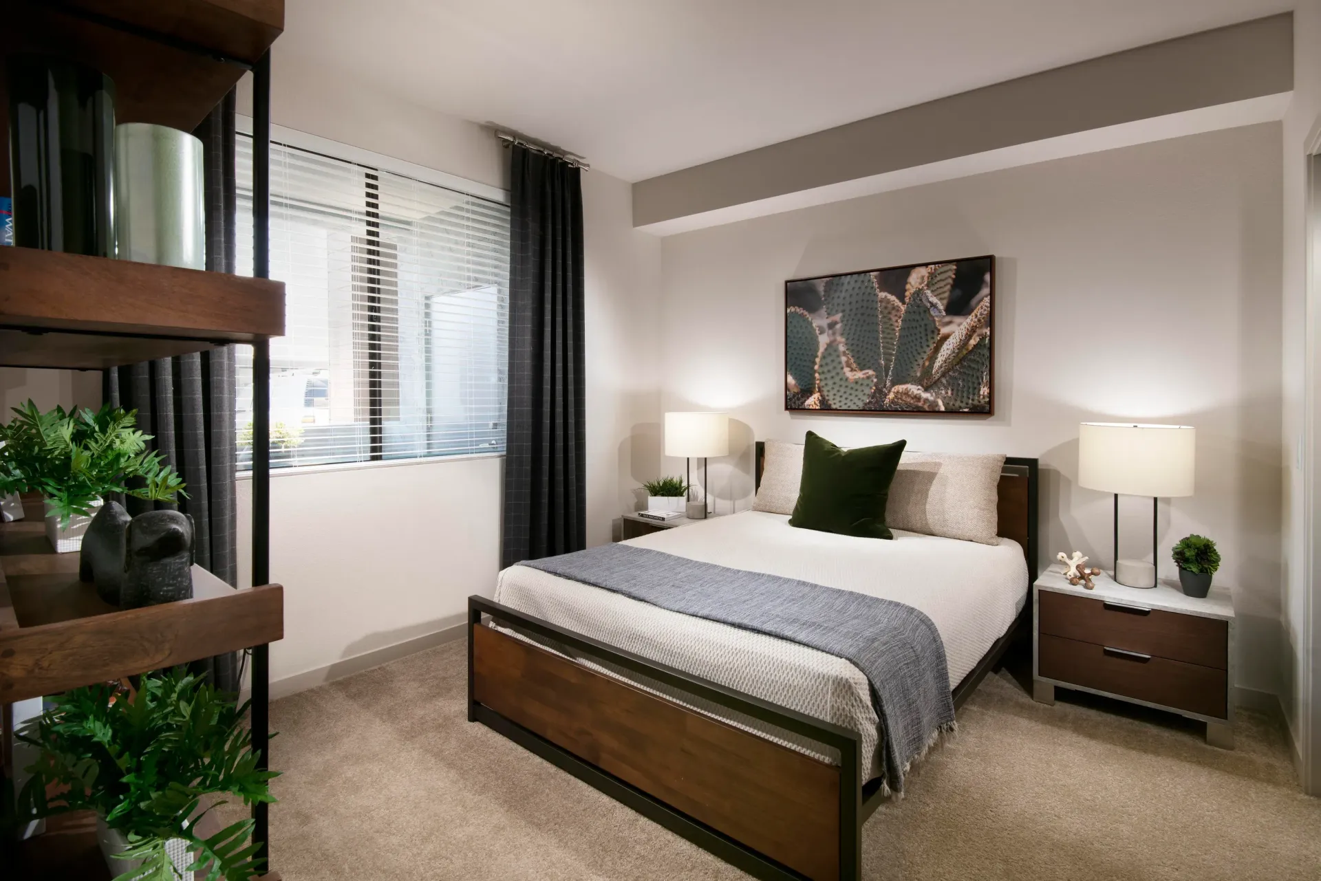 Modern bedroom with a queen-size bed, nightstand, and shelving unit at Parc South Mountain in Phoenix, AZ.