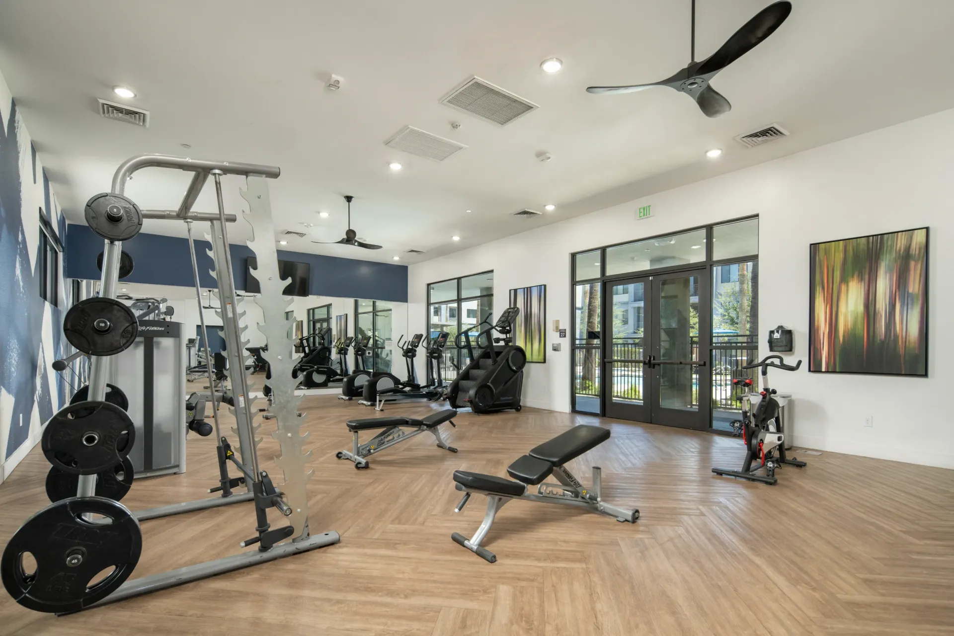 Gym with free weights, weight machines, treadmills, and stationary bikes at Parc South Mountain in Phoenix, AZ.