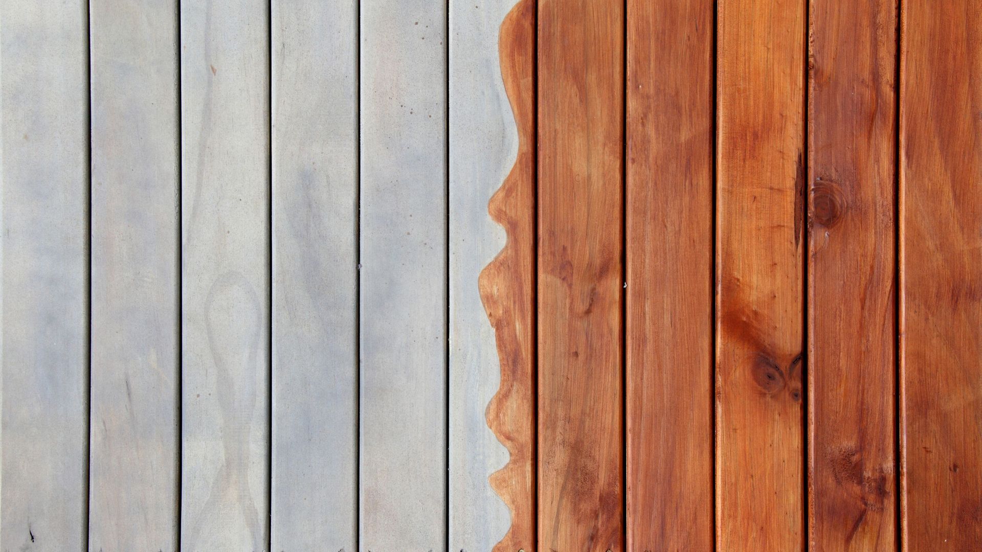 A close up of a wooden deck before and after being painted.