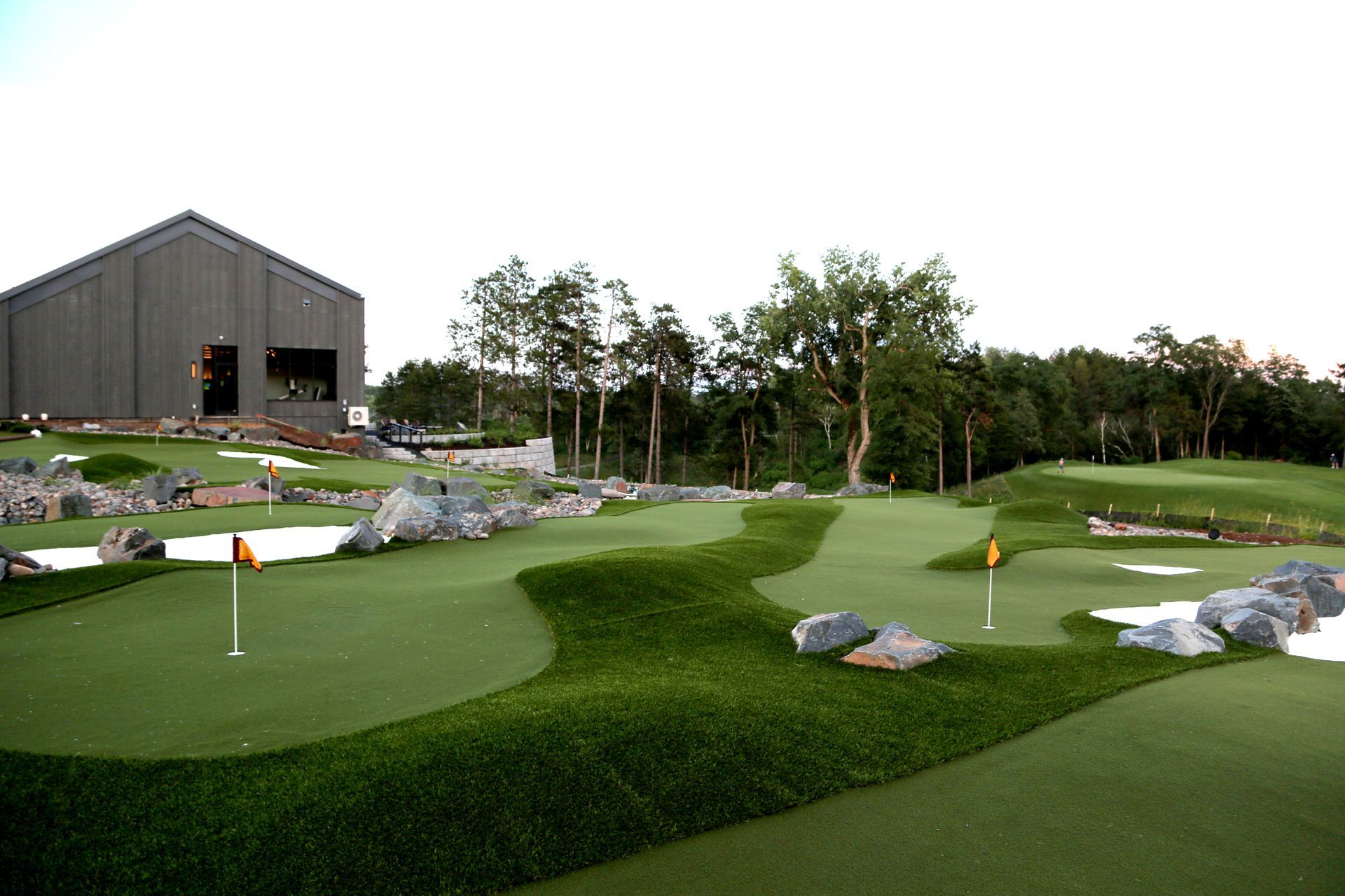 A golf course with a large building in the background