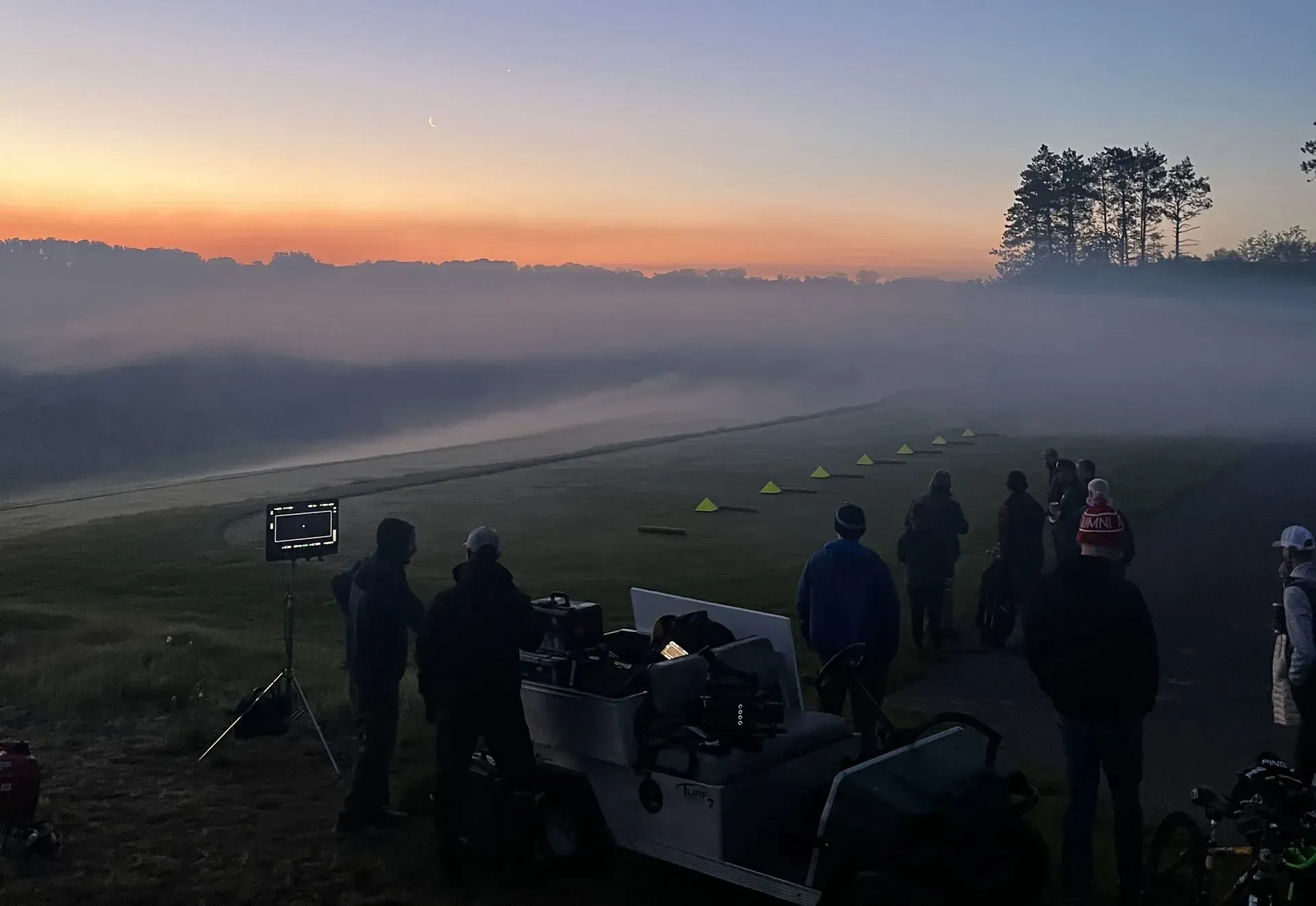 A group of people are standing in a foggy field