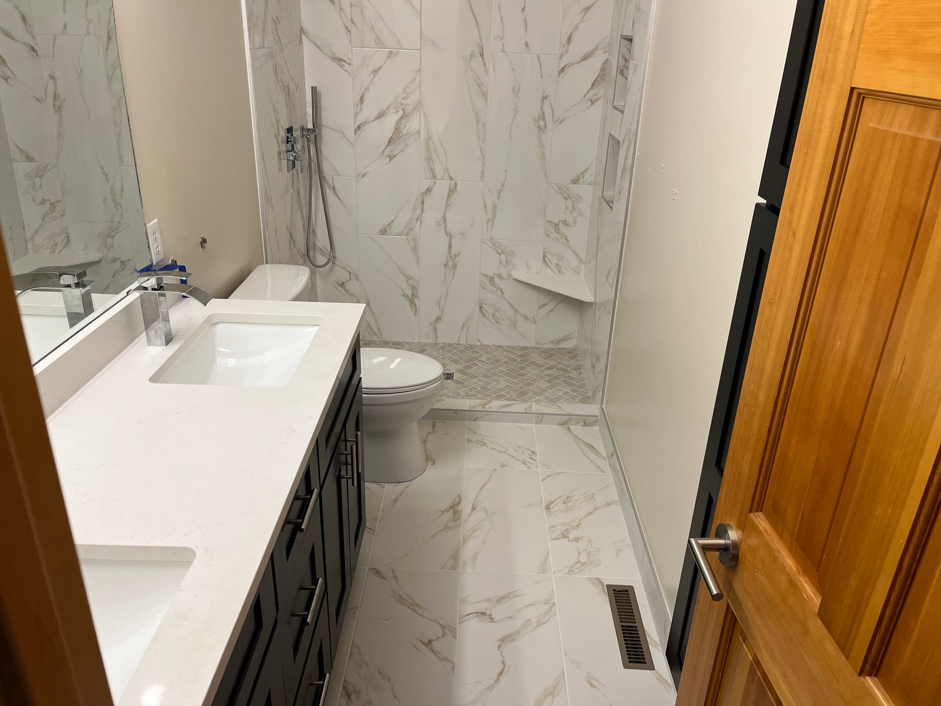 A bathroom with a sink , toilet and shower.