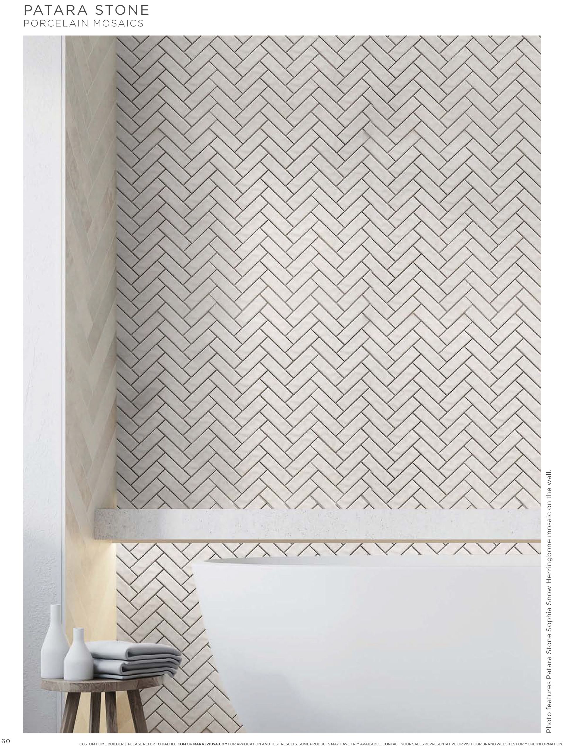 A bathroom upgrade with a herringbone pattern on the wall and a bathtub.