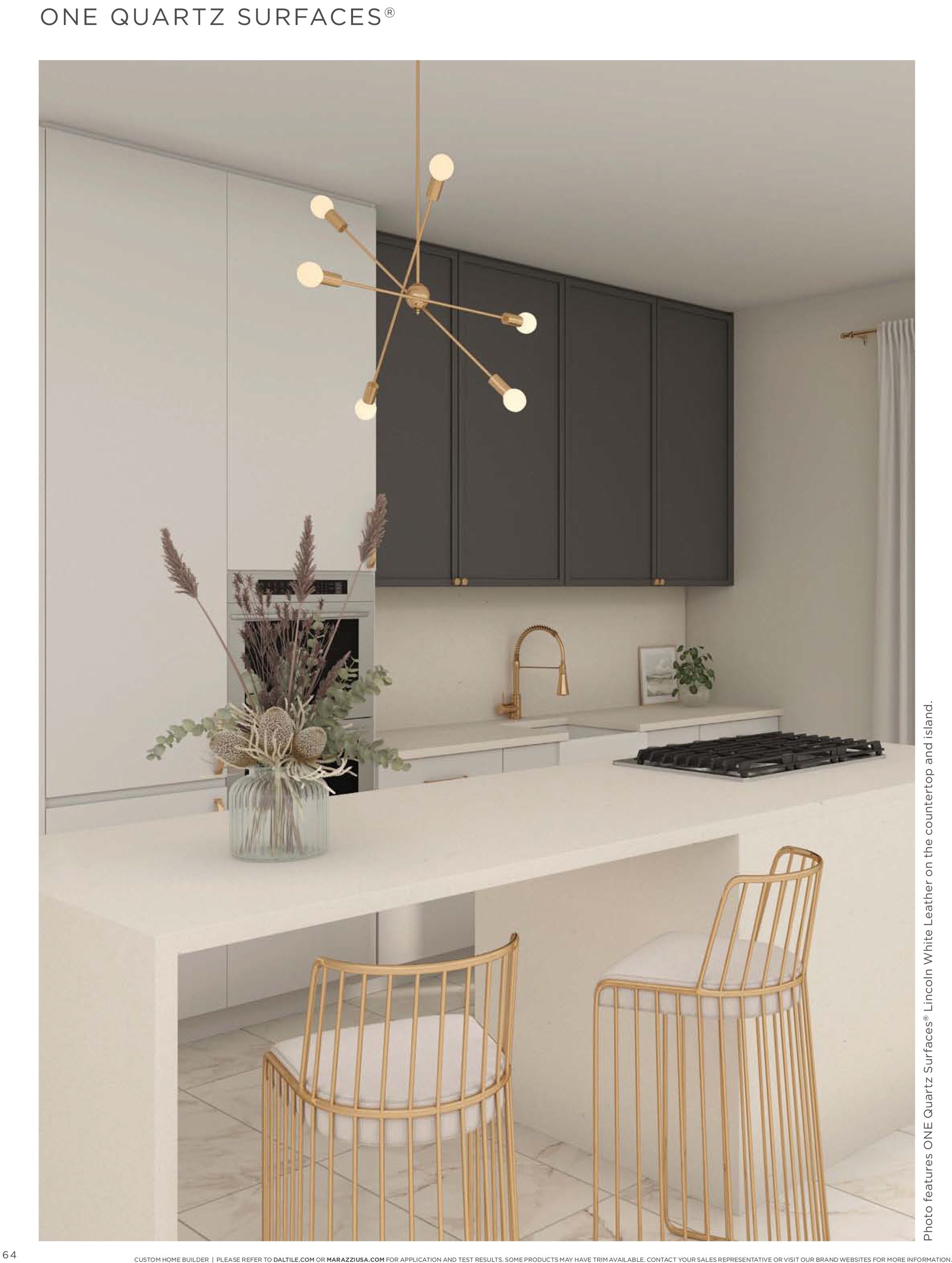Kitchen cabinetry | A kitchen with white cabinets and gold stools and a chandelier hanging from the ceiling.