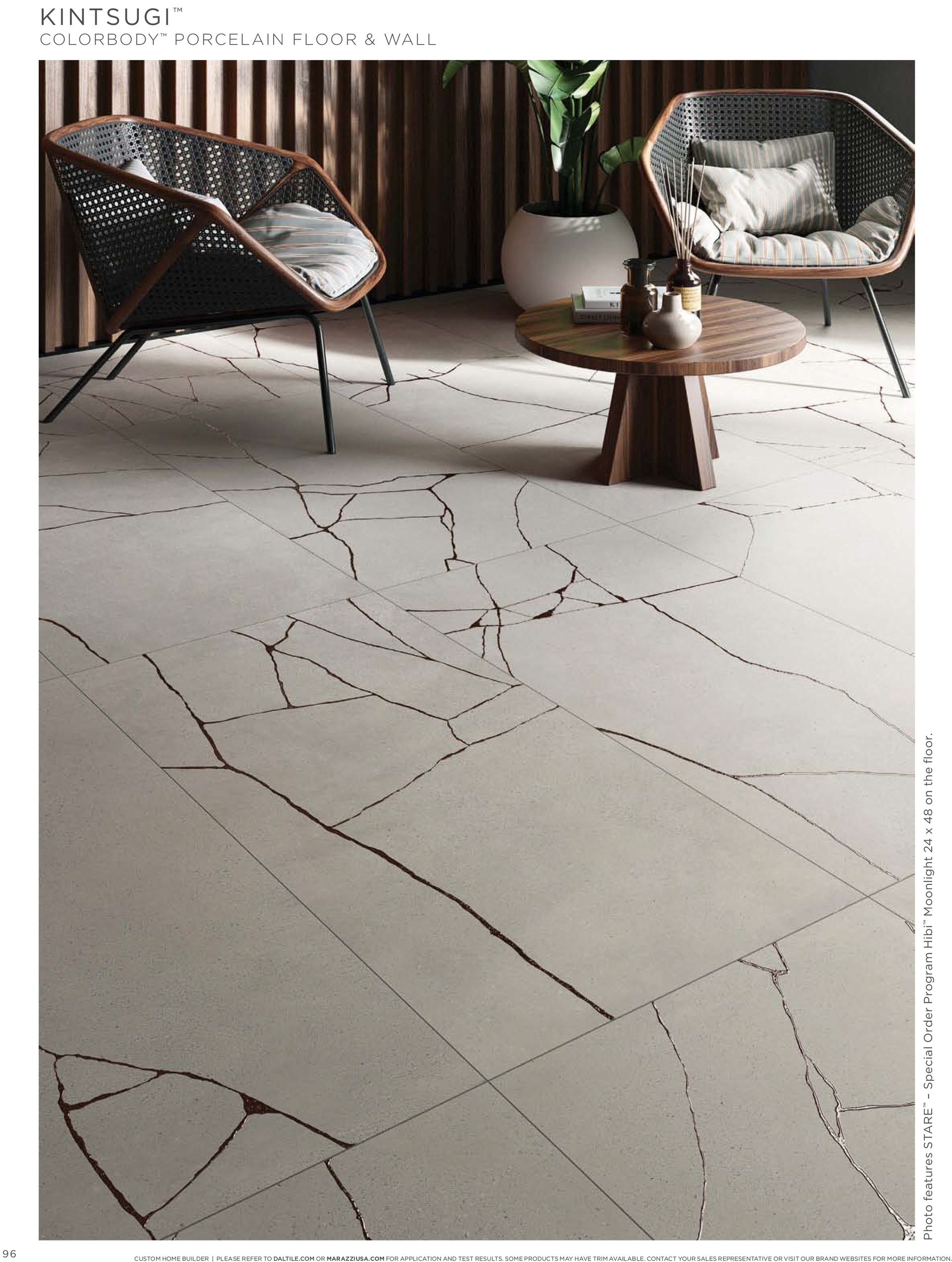 Tile floor idea | A living room with two chairs and a table.