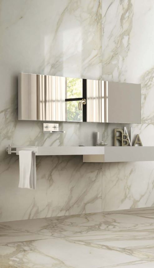 Large format tile | A bathroom with a sink and a mirror on the wall.