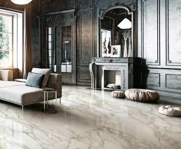 Large format tile floor | A living room with a couch , fireplace , and mirror.