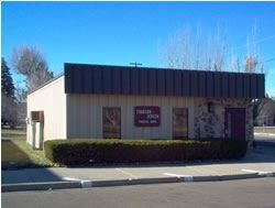 Tan and brown building with a sign that reads