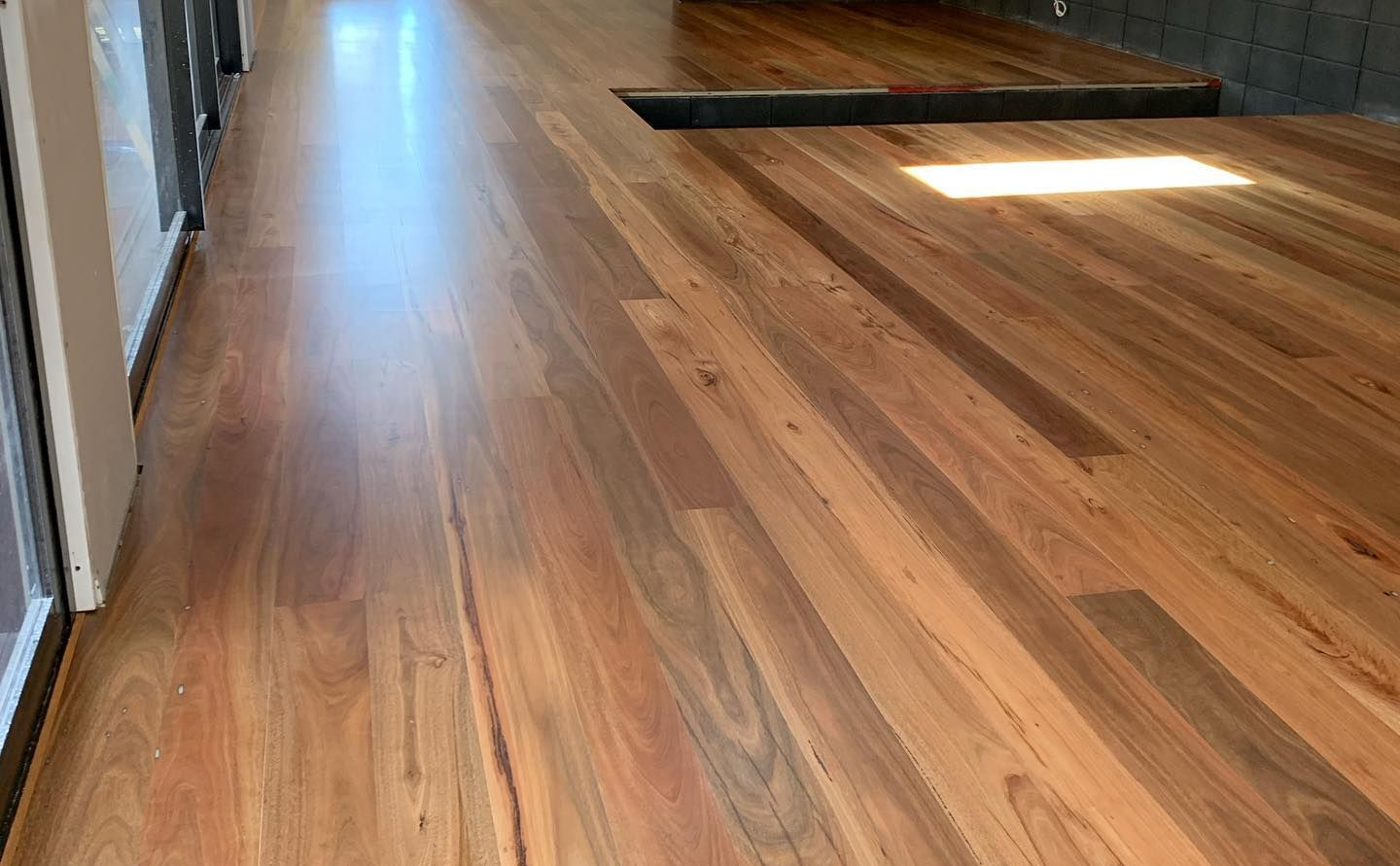 Wooden Floor With Sunlight and Window Shadows — CM Timber Flooring in East Ballina, NSW