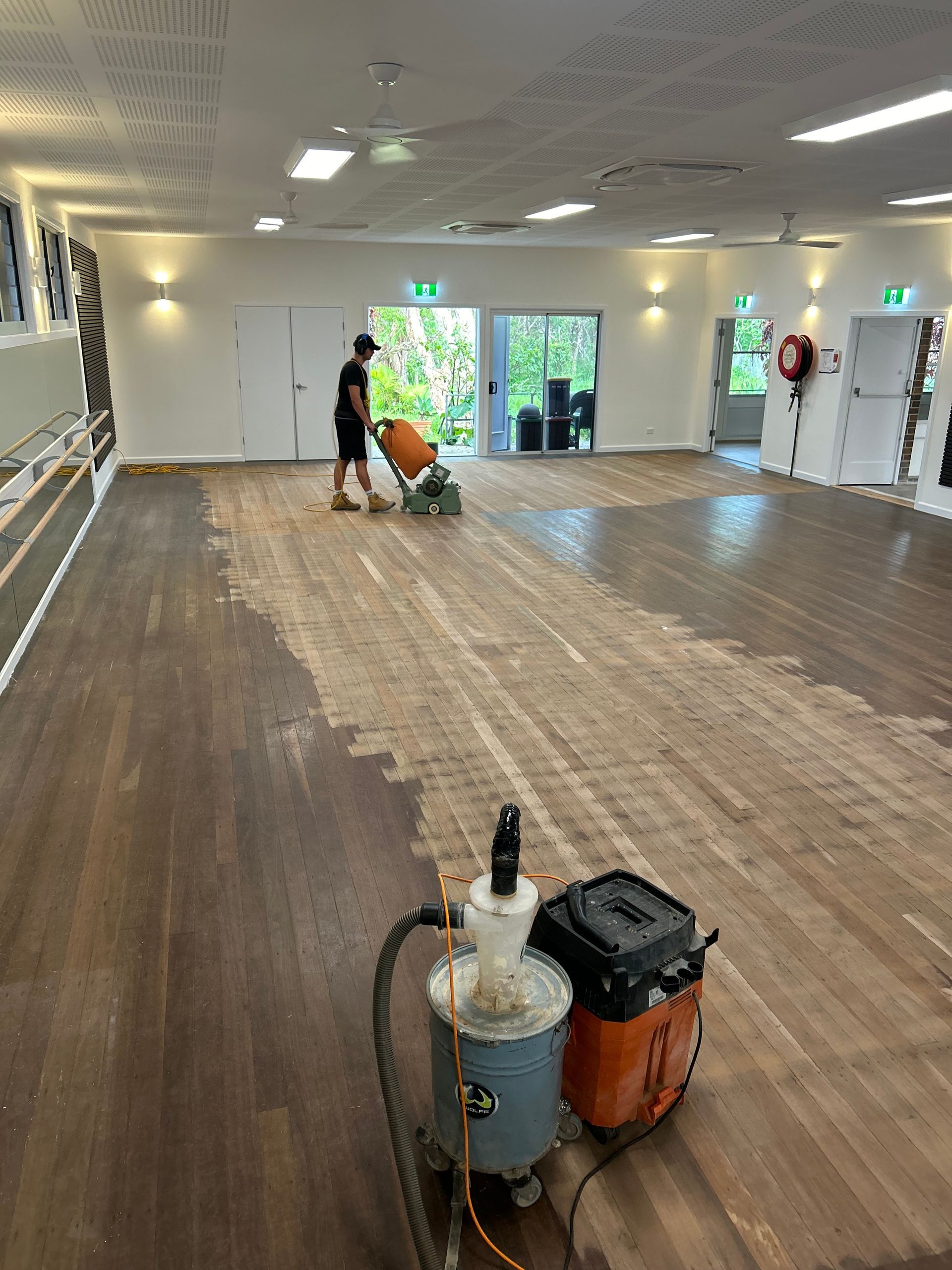Floor Sander in Action, Sanding Wooden Planks, Dust Present, Interior Setting — CM Timber Flooring in Byron Bay, NSW
