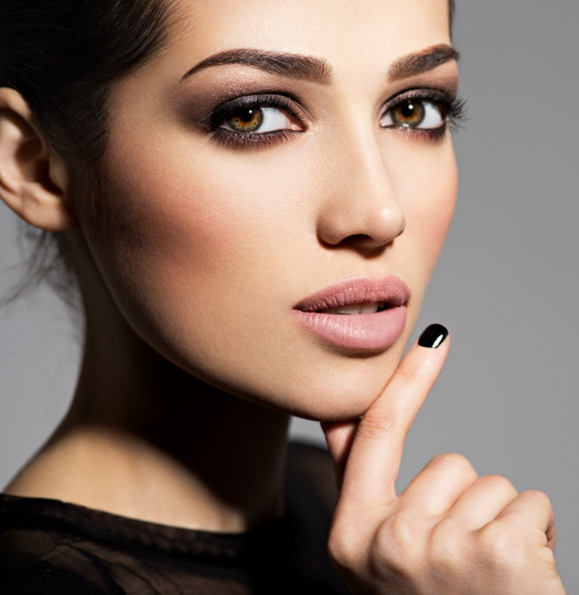 beautiful woman with glowing skin smokey eye makeup