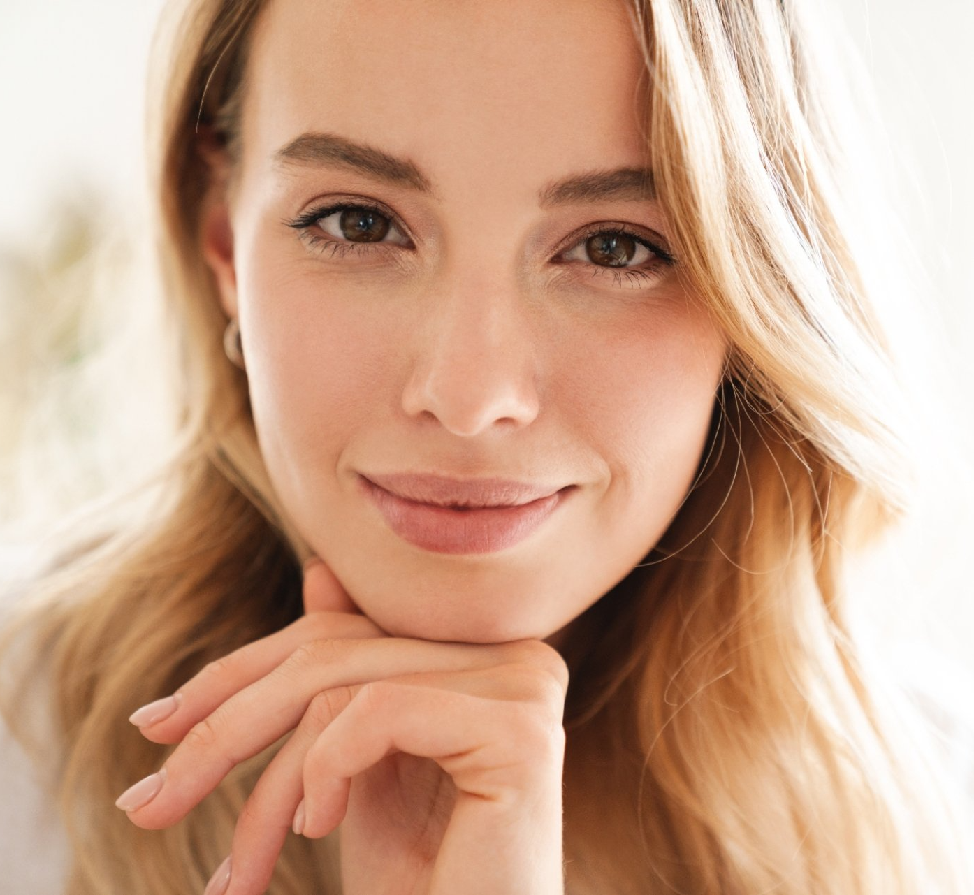 young woman with hand under her chin