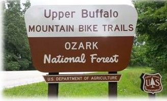 Sign for Upper Buffalo Mountain Bike Trails in Ozark National Forest, brown and white with U.S. Forest Service logo