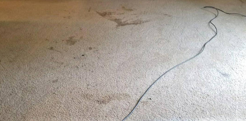 Cracked concrete surface with a long jagged fissure running diagonally across the ground.