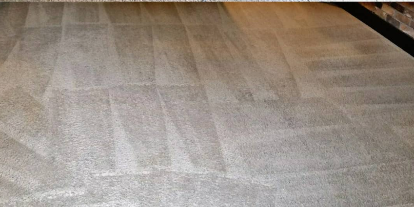 Carpeted floor with a visible light-colored stain or wear pattern across the center