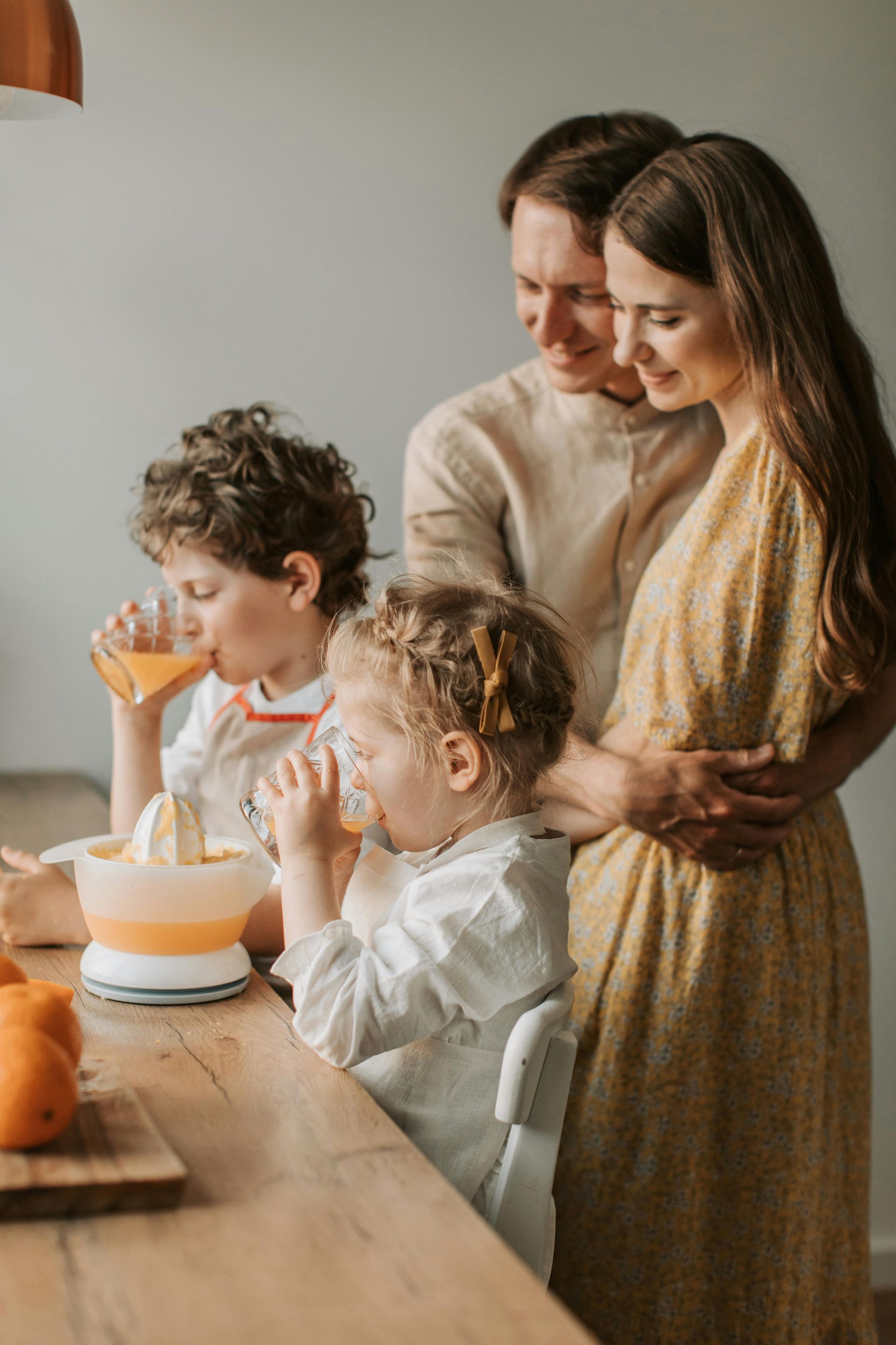 Family gathered around a table, blowing out candles on a birthday cake