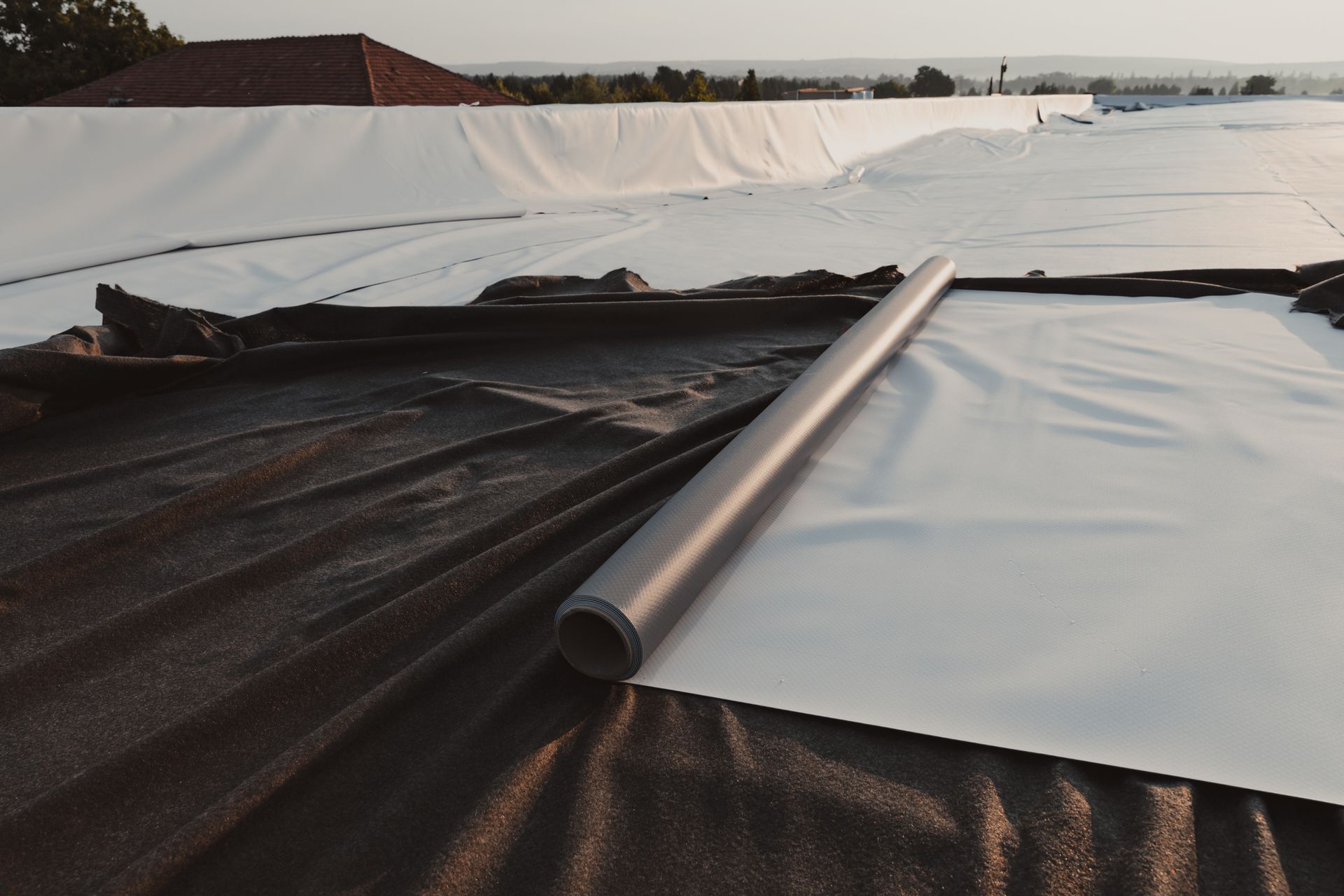 A roll of plastic is laying on a roof