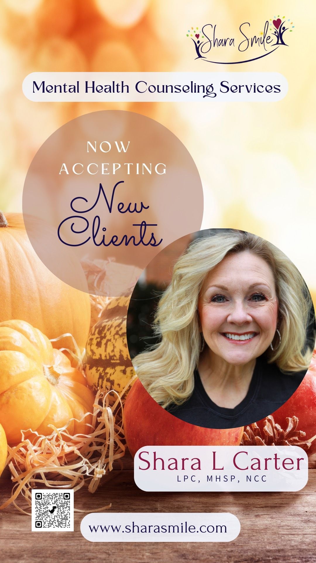 A woman is smiling in front of a pile of pumpkins. A woman is smiling in front of a pile of pumpkins.