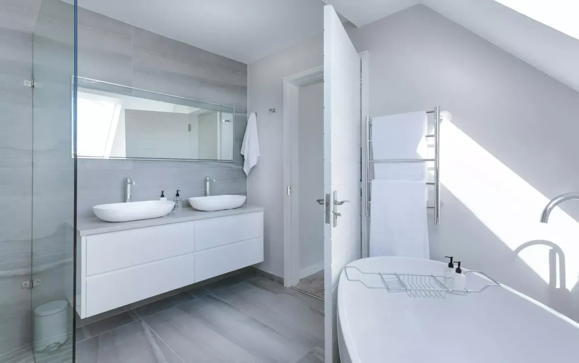 Modern bathroom with floating vanity and soaking tub showing a plumbing upgrade completed by Top Grade Plumbing in Bakersfield CA