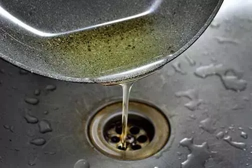 Grease and cooking oil draining into a kitchen sink creating a clog that requires hydro jetting in Bakersfield CA