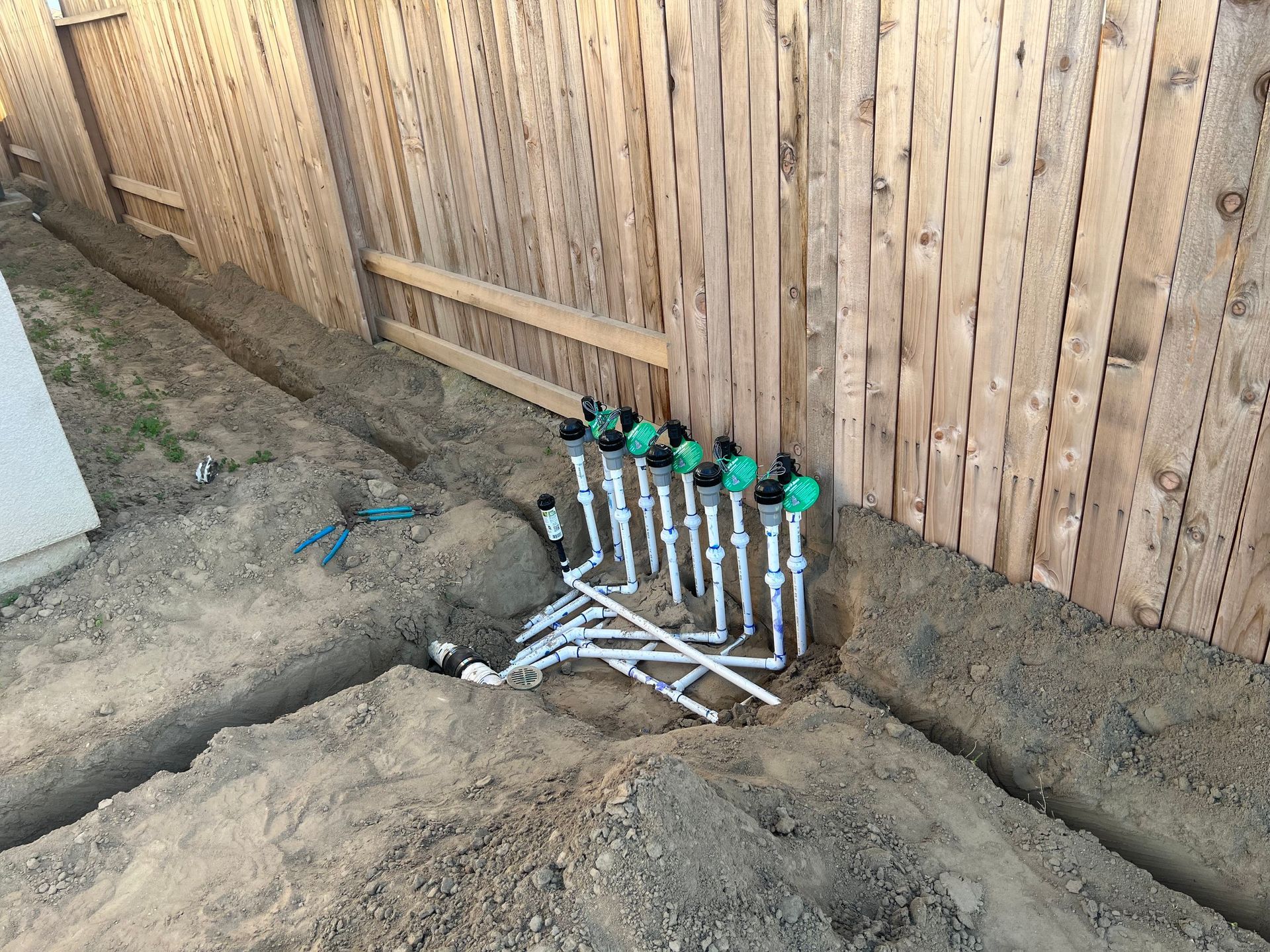 PVC pipes and fittings laid out for a plumbing installation completed by Top Grade Plumbing in Bakersfield CA