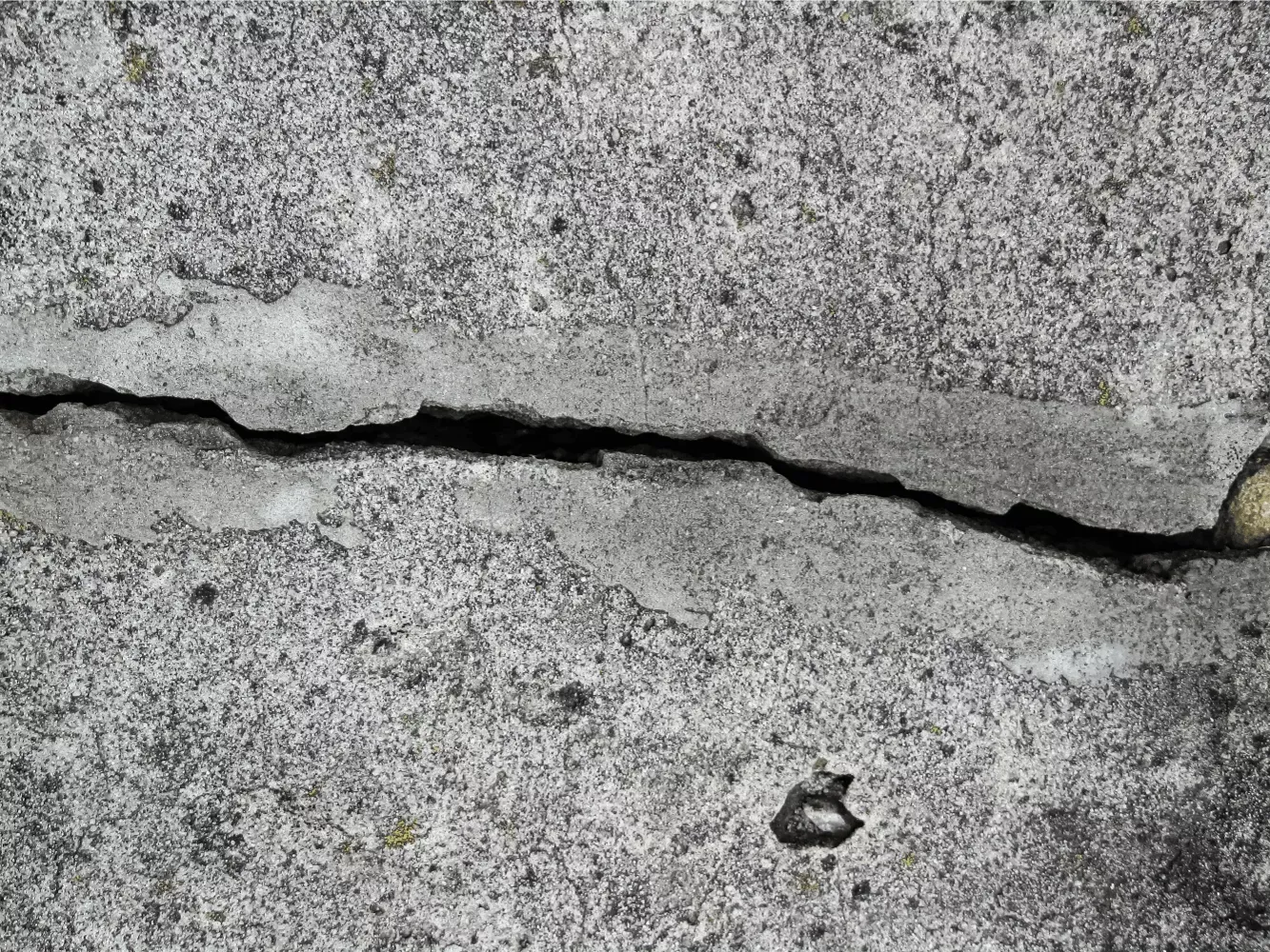 Cracked concrete slab showing signs of an underground slab leak in Bakersfield