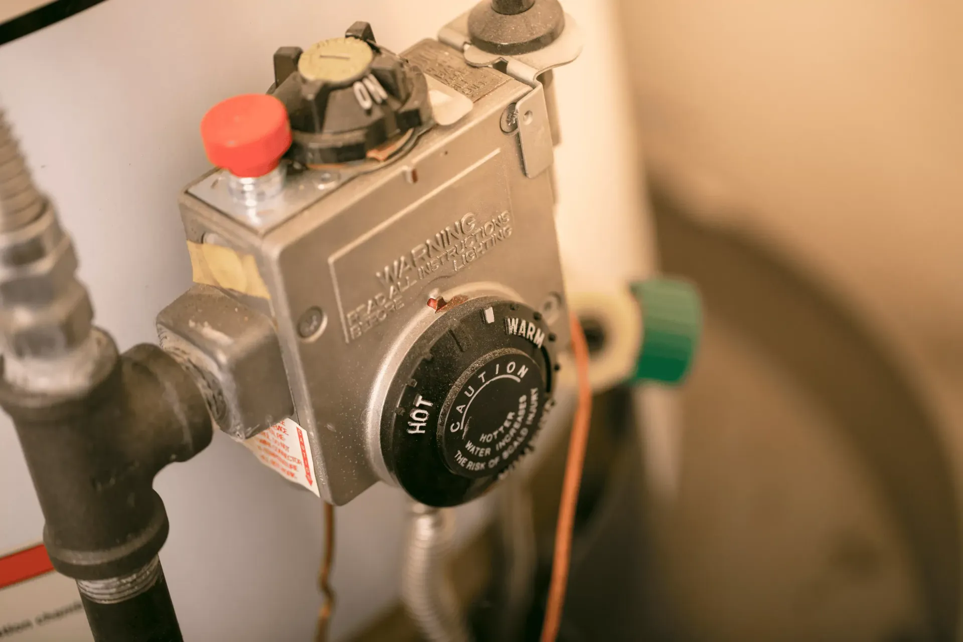 Gas control valve on a water heater being inspected and serviced by Top Grade Plumbing in Bakersfield CA
