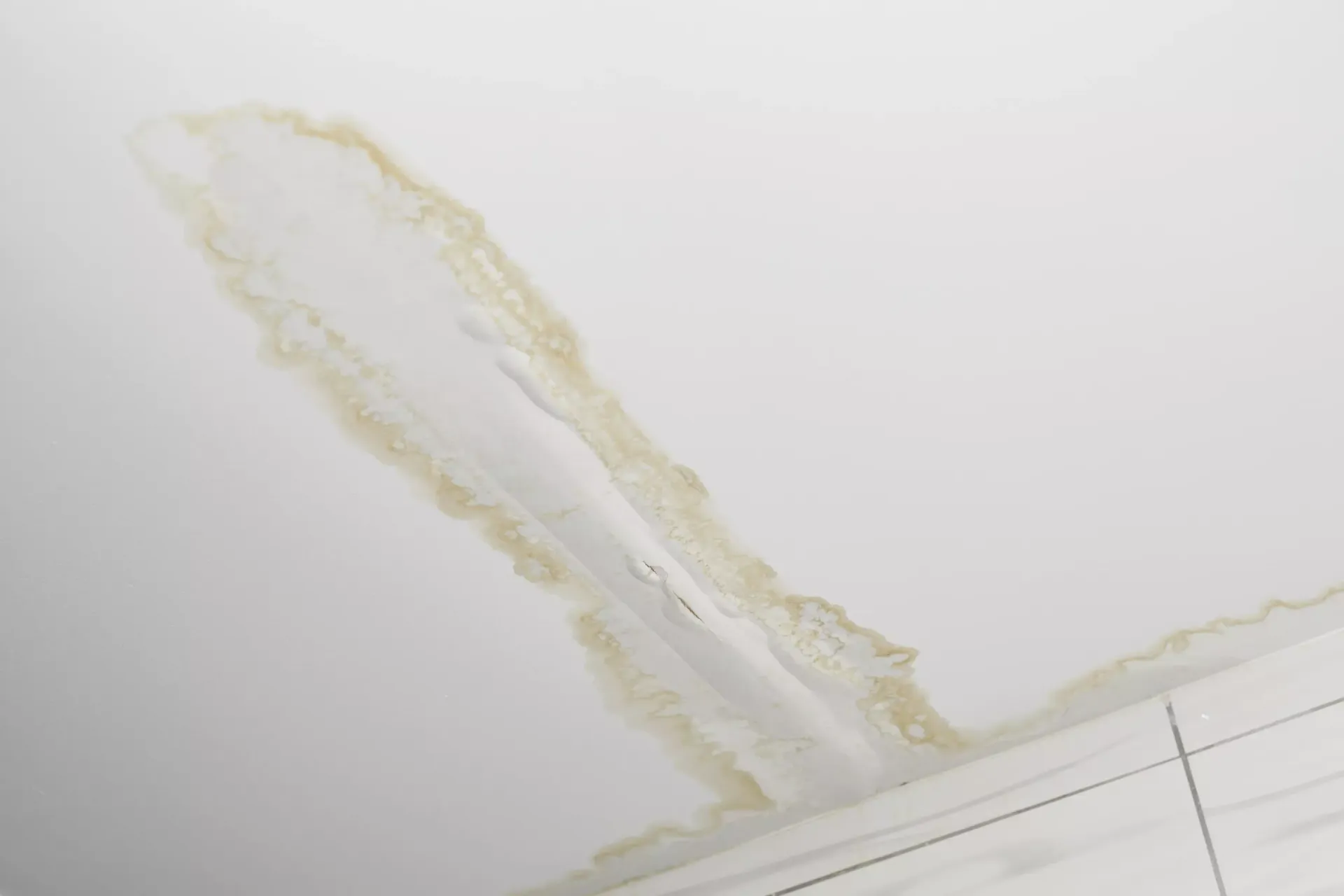 Water stain running down an interior wall from a hidden pipe leak in a Bakersfield home