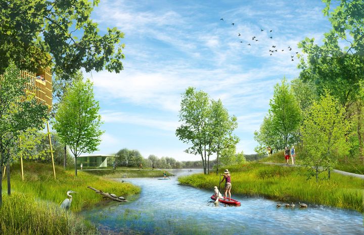 A river winds through a green park; a family paddles on the water, blue sky, trees, and a building.