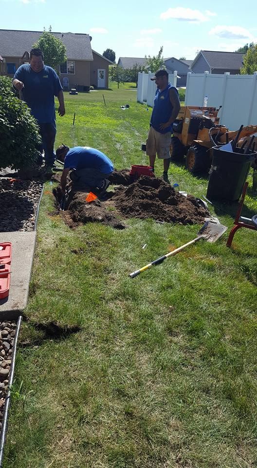 A Group of Men Are Digging in A Yard | Onalaska, WI | River City Irrigation