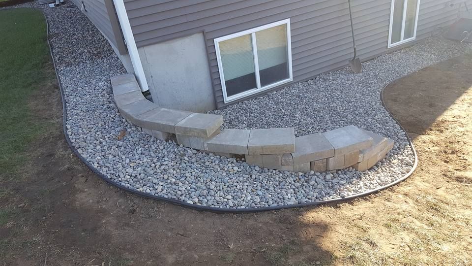 A House with A Concrete Walkway Surrounded by Gravel in Front of It | Onalaska, WI | River City Irrigation